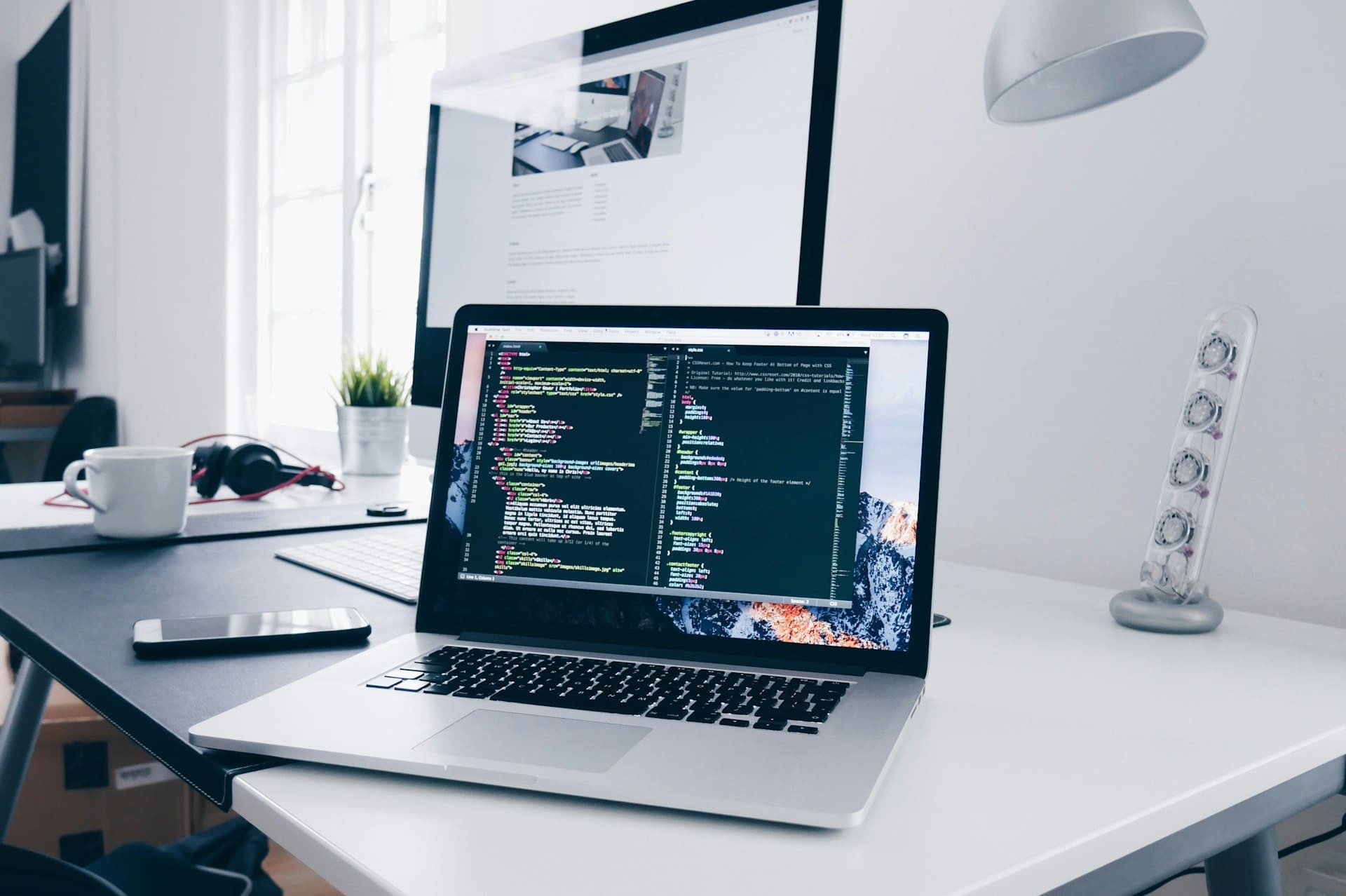 A MacBook with code on the screen.